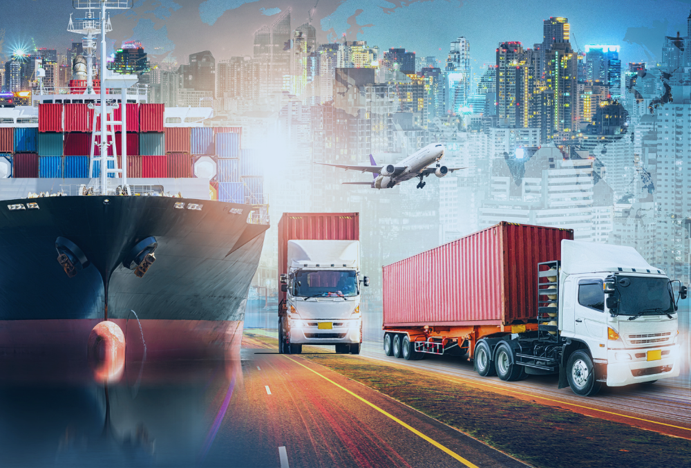 Two red and white large lorries featured alongside a large ship, a plane taking off against a cityscape background