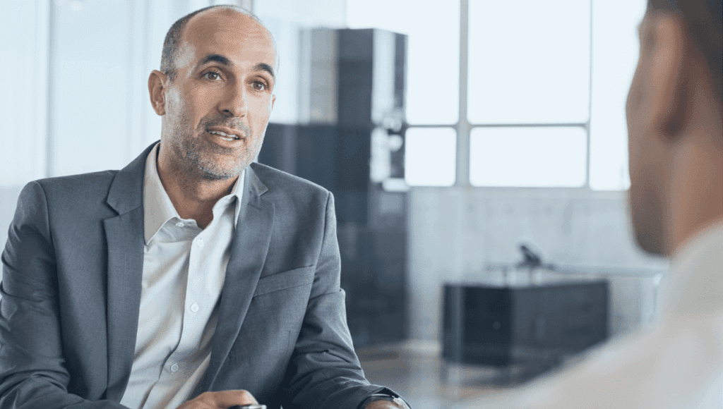 smartly dressed professional delivers careers advice in an office setting