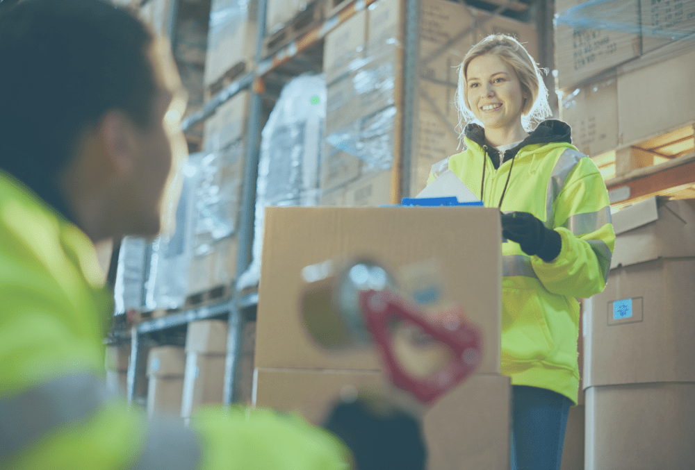 A young female employee on a supply chain warehouse operative apprenticeship in a warehouse setting