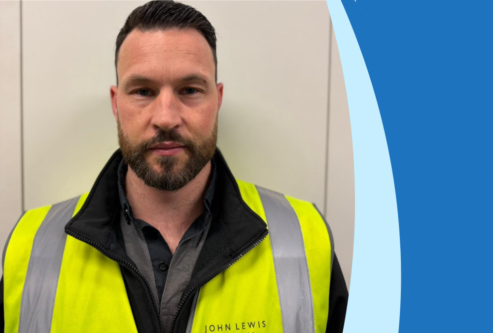 Portrait of a man in a high-visibility vest and John Lewis & Partners uniform, facing the camera.