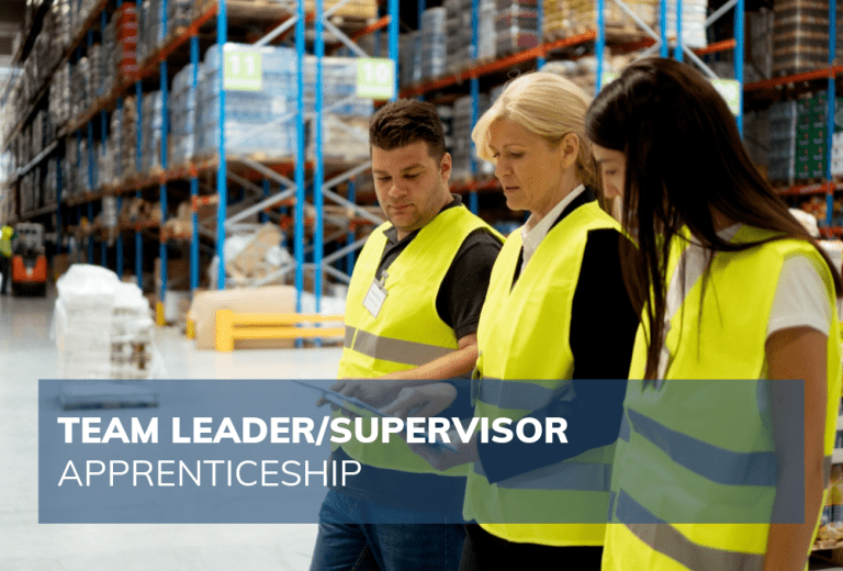 woman in hi vis jacket in warehouse instructs two other members of staff