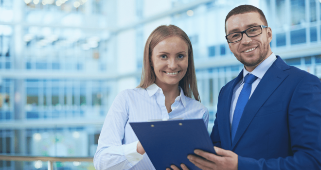 Smiling Male HR support partner and smiling female employer in a business setting