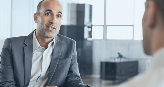 smartly dressed professional delivers careers advice in an office setting